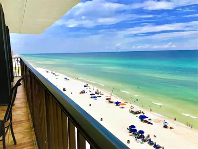 a view of a beach with umbrellas and the ocean at Pelican Walk 1006/1007 in Panama City Beach
