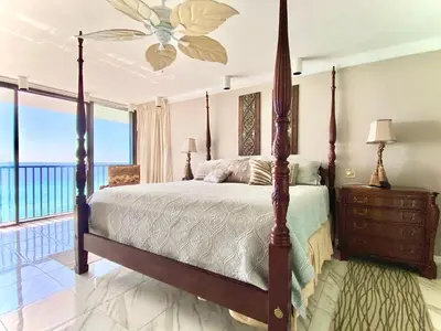 a bedroom with a bed with a view of the ocean at Pelican Walk 1006/1007 in Panama City Beach