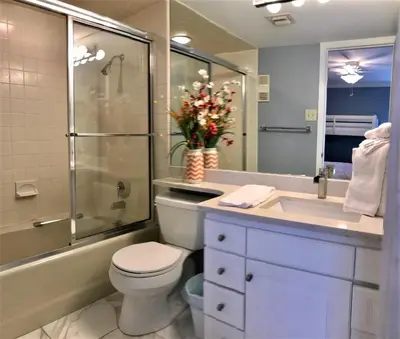 a bathroom with a toilet and a shower and a sink at Pelican Walk 1006/1007 in Panama City Beach