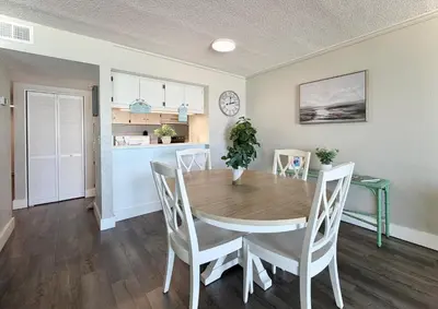 a kitchen and dining room with a table and chairs at Gulfgate 205 in Panama City Beach