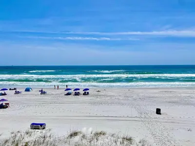 a beach with umbrellas and people on the beach at Gulfgate 301 in Panama City Beach