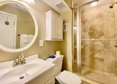 a bathroom with a toilet and a sink and a shower at Gulfgate 201 in Panama City Beach