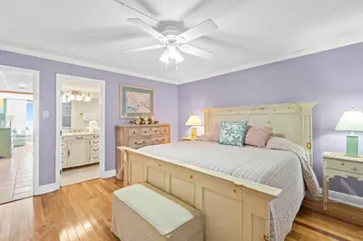 a bedroom with a bed and a ceiling fan at Pelican Walk 107 in Panama City Beach