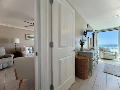 a room with a door leading to a living room with a view at Gulfgate 204 in Panama City Beach