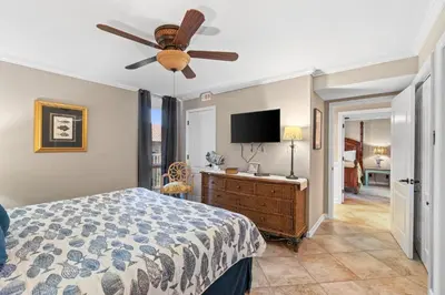 a bedroom with a bed and a ceiling fan at Pelican Walk 307 in Panama City Beach