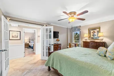 a bedroom with a bed and a ceiling fan at Pelican Walk 307 in Panama City Beach
