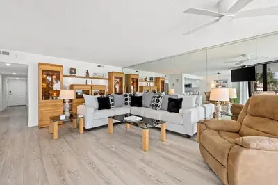 a living room with two couches and a table at Pelican Walk 207 in Panama City Beach