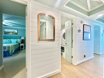 a room with a bed and a mirror on the wall at Pelican Walk 206 in Panama City Beach