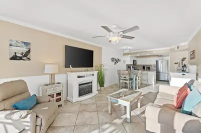 a living room with a couch and a tv at Pelican Walk 510 in Panama City Beach