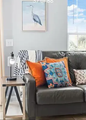 a living room with a couch and a table with pillows at Coastal Castaway-Beach Retreat-Steps 2 Sand-Sleep 10-Pool-Hot tub in Panama City Beach