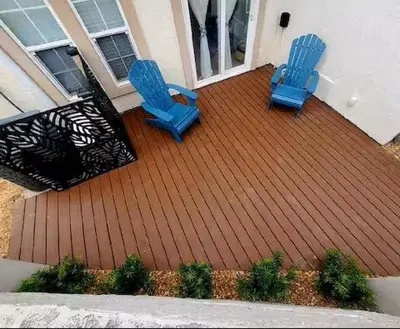 two blue chairs sitting on a deck on a house at Coastal Castaway-Beach Retreat-Steps 2 Sand-Sleep 10-Pool-Hot tub in Panama City Beach