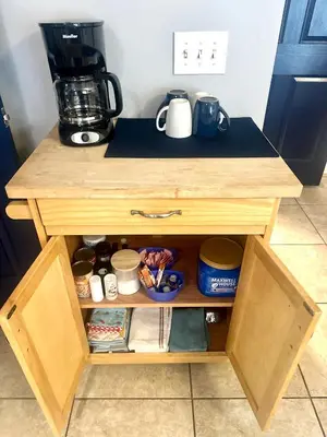 a wooden cabinet with food items on it at Coastal Castaway-Beach Retreat-Steps 2 Sand-Sleep 10-Pool-Hot tub in Panama City Beach