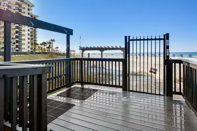 a wooden deck with a view of the beach at Sunbird Beach Resort 1011W By Book That Condo in Panama City Beach