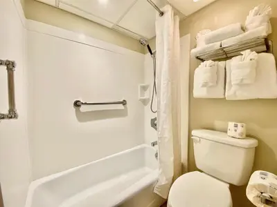 a bathroom with a toilet and a bath tub at Casa Blanca Resort Studio Loft in Panama City Beach