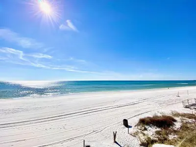 a view of a beach with the sun and the ocean at Casa Blanca Resort Studio Loft in Panama City Beach