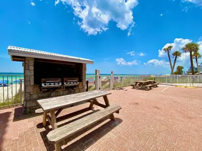 a picnic bench sitting next to the beach at Casa Blanca Resort Studio Loft in Panama City Beach