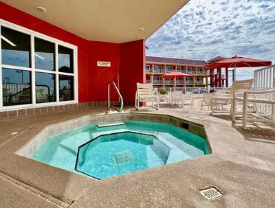 a swimming pool in the middle of a patio with tables and chairs at Casa Blanca Resort Studio Loft in Panama City Beach