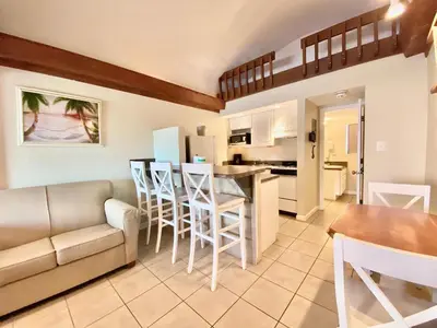 a living room and kitchen with a couch and a table at Casa Blanca Resort Studio Loft in Panama City Beach