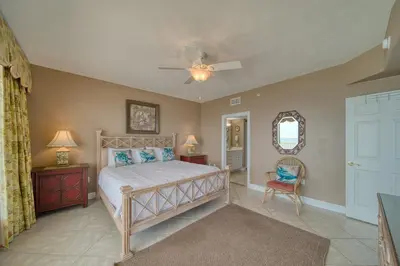 a bedroom with a bed and a ceiling fan at Treasure Island 0901 in Panama City Beach