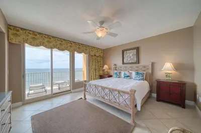 a bedroom with a bed with a view of the ocean at Treasure Island 0901 in Panama City Beach