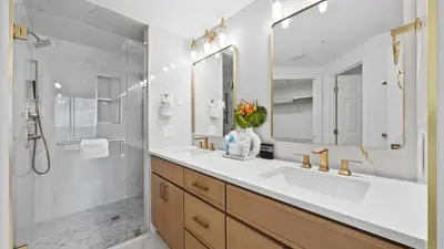 a white bathroom with a sink and a shower at Treasure Island 1405 in Panama City Beach