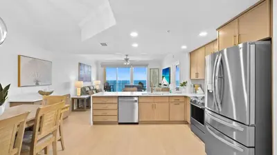 a large kitchen with a stainless steel refrigerator at Treasure Island 1405 in Panama City Beach