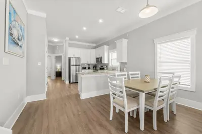 a kitchen and dining room with a table and chairs at 22704 Front Beach Road | Ocean Breeze in Panama City Beach