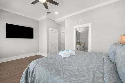 a bedroom with a bed and a flat screen tv at 22704 Front Beach Road | Ocean Breeze in Panama City Beach