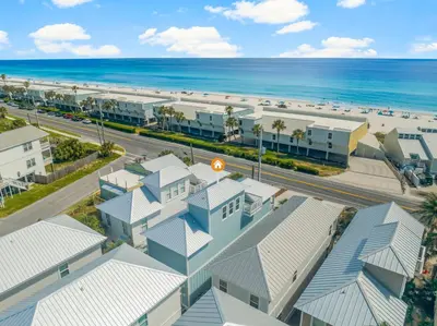 an aerial view of a resort with the beach at 22704 Front Beach Road | Ocean Breeze in Panama City Beach