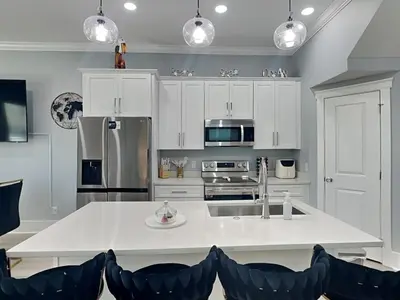 a kitchen with white cabinets and a white counter top at Ocean Pearl Villa in Panama City Beach