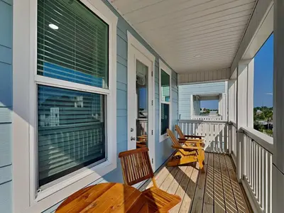 a porch with a table and chairs on it at Ocean Pearl Villa in Panama City Beach