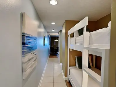 a corridor of a dorm room with bunk beds at Grand Panama Beach Resort - The Grand II #803 in Panama City Beach