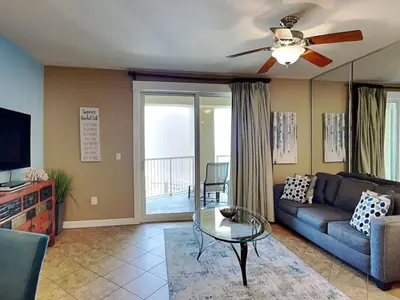a living room with a couch and a ceiling fan at Grand Panama Beach Resort - The Grand II #803 in Panama City Beach