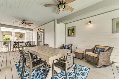 a dining room with a wooden table and chairs at No Ragrets in Inlet Beach