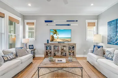 a living room with two couches and a table at No Ragrets in Inlet Beach