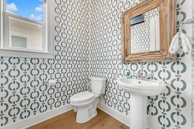 a bathroom with a toilet and a sink and a mirror at No Ragrets in Inlet Beach