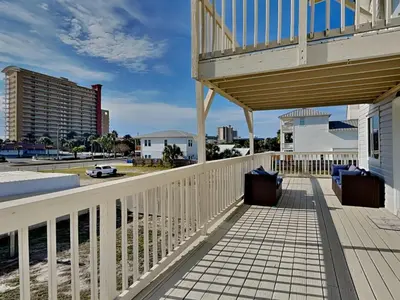 a balcony of a house with a wooden deck at PC Beach Retreat C in Panama City Beach