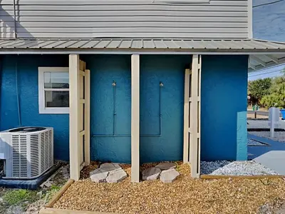 a blue house with two doors on it at PC Beach Retreat C in Panama City Beach
