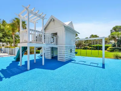 a play house with a slide on a playground at Relax Awhile - Carriage House in Panama City Beach