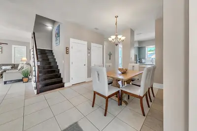 a dining room and living room with a table and chairs at Relax Awhile - Main House in Panama City Beach