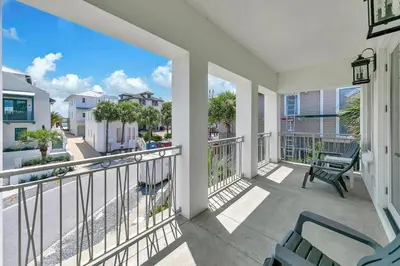a balcony with chairs and a view of a street at Relax Awhile - Main House in Panama City Beach