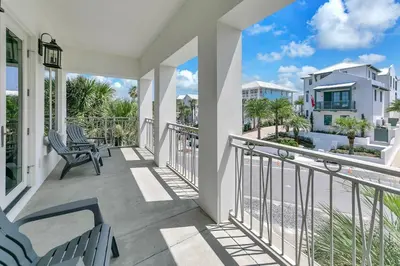 a balcony with chairs and a view of the ocean at Relax Awhile - Main House in Panama City Beach