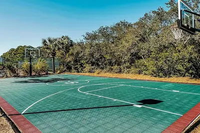 a tennis court with a basketball hoop on it at Relax Awhile - Main House in Panama City Beach