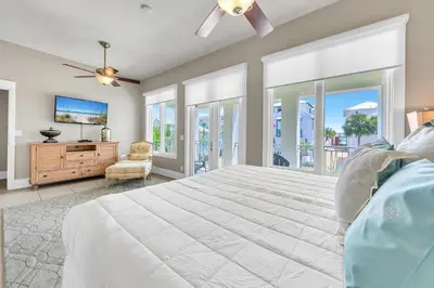 a bedroom with a large bed and a tv at Relax Awhile in Panama City Beach