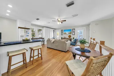 a kitchen and living room with a table and chairs at Relax Awhile in Panama City Beach