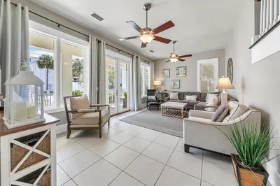 a living room with chairs and a ceiling fan at Relax Awhile in Panama City Beach