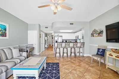 a living room with a couch and a table at Calypso 2-103 West in Panama City Beach