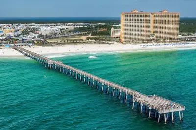 an aerial view of a pier next to a beach at Calypso 2-103 West in Panama City Beach