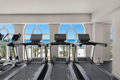 a gym with a row of treadmills at Calypso 2-103 West in Panama City Beach