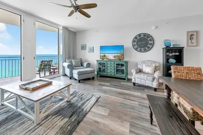 a living room with a view of the ocean at Aqua Resort 905 by Emerald Coast Retreats in Panama City Beach